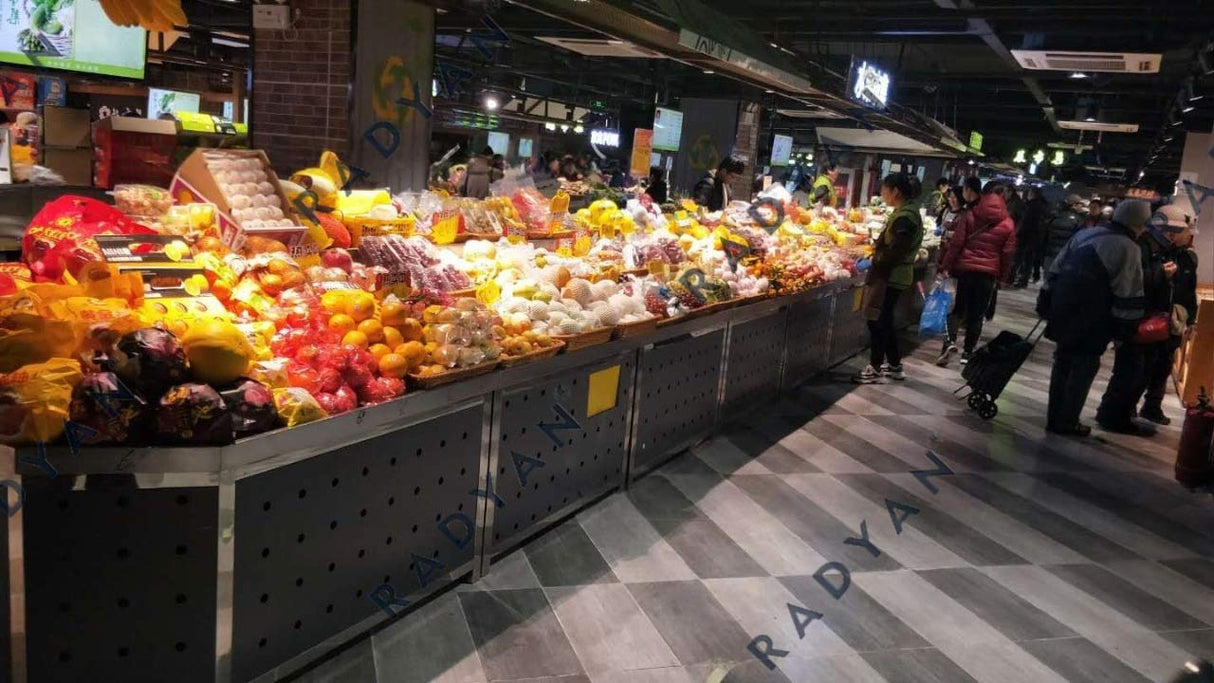 Farmers market transformation with fruit and vegetable racks, dividing table and fish pond